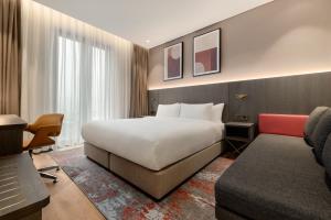a hotel room with a bed and a couch at Ramada by Wyndham Arnavutkoy in Istanbul +65 photos