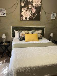 a bedroom with a large bed with a yellow pillow at Cottage on Kort Deluxe in Parys