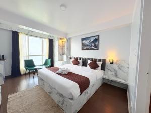 a hotel room with a large bed and a window at Singalila Retreat by Barsana Group Darjeeling in Darjeeling +22 photos