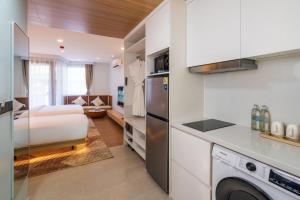 a kitchen and a bedroom with a bed in a room at Wyndham Garden Samui Wing in Chaweng