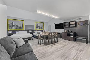 a living room with a couch and a dining room at Super 8 by Wyndham Texas City - Galveston Area in Texas City