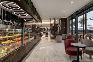 a restaurant with a display case filled with pastries at Ramada by Wyndham Arnavutkoy in Istanbul