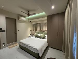 a bedroom with a bed and a ceiling fan at Dormstel - Unit of AHM Hotels & Resorts Pvt Ltd in Vadodara