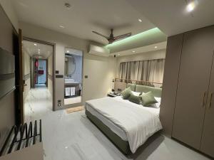 a bedroom with a large bed with a ceiling at Dormstel - Unit of AHM Hotels & Resorts Pvt Ltd in Vadodara