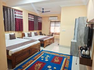 a hotel room with two beds and a rug at Diamond Blue Residency in Durgāpur
