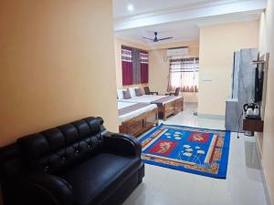 a living room with a bed and a couch at Diamond Blue Residency in Durgāpur