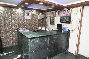 a bar with a green counter in a room at Hotel Bluebell Inn in Lucknow +17 photos