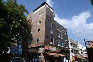 a tall building on the side of a street at Hotel Bluebell Inn in Lucknow