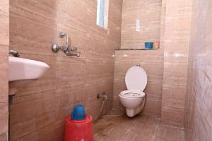 a bathroom with a toilet and a sink at Hotel Bluebell Inn in Lucknow