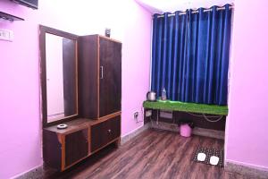 a bathroom with a blue shower curtain and a sink at Hotel Bluebell Inn in Lucknow