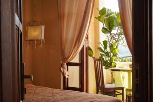 a bedroom with a bed and a window with a table at Dreamershomecoffee in Xuan An