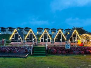 a building with lights on it at night at Camping At Pawana in Malavli