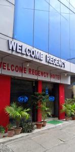 a welcome recovery hotel with plants in front of it at Welcome Regency in kolkata