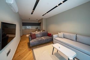 a living room with a couch and a table at Moon Shine Apart in Altınkum