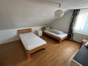 a small room with a bed and a couch at XL Apartment Rödermark 4SZ in Rödermark