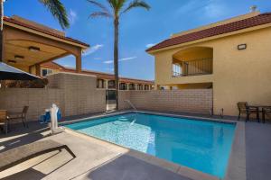 a swimming pool in front of a house at Travelodge by Wyndham Banning Casino and Outlet Mall in Banning