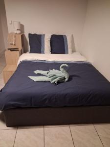 a bed with a dinosaur on top of it at Au deuxième in Nogent-sur-Seine