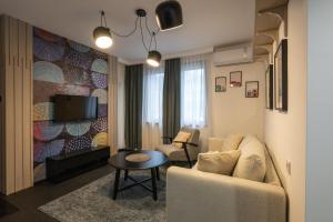 a living room with a couch and a table at Къща Рустик in Belogradchik