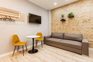 a living room with a couch and chairs and a table at ApartHotel Riga Self Registration & Check-in in Riga