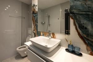 a bathroom with a sink and a toilet at Къща Рустик in Belogradchik +92 photos