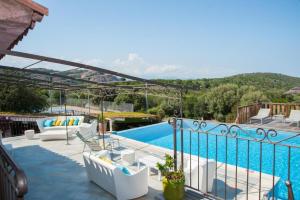 a view of a pool from a house with a balcony at Domaine de Sonia - Logements éco-insolites in Porto-Vecchio