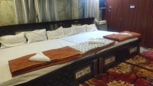 a large bed with towels on top of it at DD Gardens in Rāmeswaram