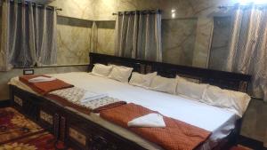 a bed with two towels on it in a room at DD Gardens in Rāmeswaram