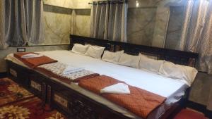a bedroom with a bed with two towels on it at DD Gardens in Rāmeswaram