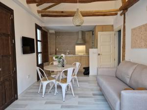 a living room with a couch and a table and chairs at Casa Garam in Granada +14 photos