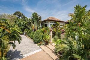 an aerial view of a house with palm trees at Villa Oxavia in Rawai Beach