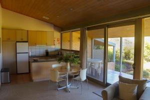 a kitchen and dining room with a table and chairs at Gipsy Point Lakeside in Gipsy Point
