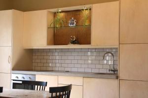 a kitchen with a table and a cat sitting on a shelf at Storytellers Cottage in Doolin
