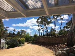 a view from the inside of a house with a dirt road at Cromwell Lite in Cooma