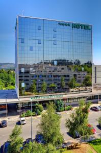 a building with a sign on the side of it at Oca Puerta del Camino Hotel in Santiago de Compostela