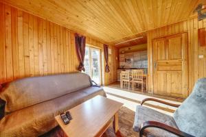 a living room with a couch and a table at Domek u Małysza in Istebna