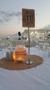 a table with a plate of food and a sign on it at Hotel Aphroditi Island Park in Alexandroupoli