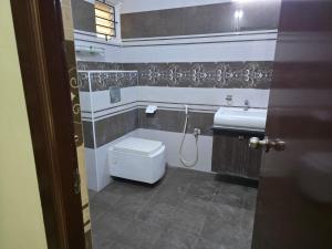 a bathroom with a toilet and a sink at GT Homestay in Chennai