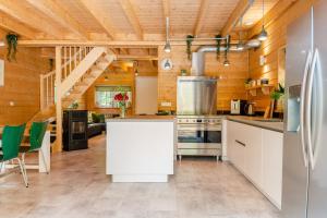 a kitchen with a white island in a room at Chalet Citola in Nuenen
