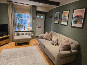 a living room with a couch and a television at The Cobbles in Skipton