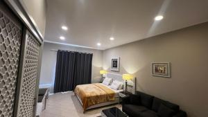 a hotel room with a bed and a couch at Dream Royal Residence in 6th Of October