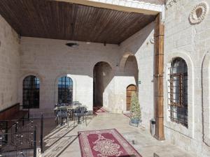 a courtyard with a table and chairs in a building at Sıla Konağı Hotel in Mardin