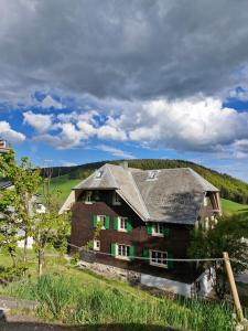 a large brick house with a gray roof at theBlackwood in Todtnauberg