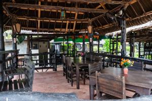 a restaurant with wooden tables and chairs and flowers at Mook Lanta Eco Resort in Ko Lanta