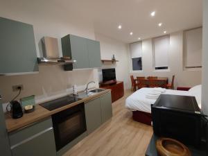 a kitchen with a sink and a bed in a room at Patecchio2-IEO Fondazione Prada Villaggio Olimpico in Vigentino