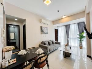 a living room with a table and a couch at Modern 1BR w Exclusive Pool Access in Lapu Lapu City