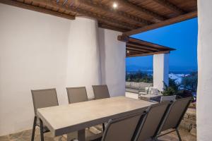 a table and chairs on a patio with a view at Seaview Villa Euterpe in Ambelas