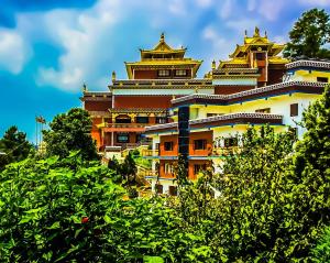 an orange and white building with pagoda at BIG J'S Farm House in Dhulikhel