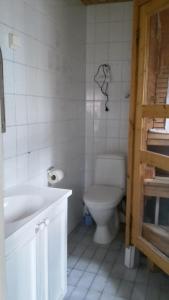 a bathroom with a toilet and a sink and a tub at Kirkkokadun Amanda ja Olga in Uusikaupunki +14 photos