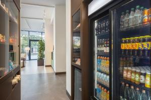 a refrigerator full of drinks in a store at Courtyard by Marriott Milano Linate in Milan