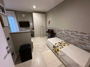 a bedroom with a bed and a brick wall at Bed & Breakfast Indi Thelar in Villa Guardia